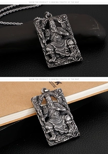 Macro shot of Guan Yu relief pendant in vintage silver steel with intricate dragon motifs