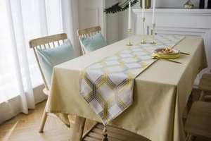 Macro shot of Chenille jacquard table runner with yellow grey patterns and tassels