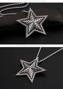 Macro shot of vintage star pendant with textured geometric rays and rope chain details