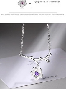 Detail of silver flower necklace with purple gemstone and 12mm cherry blossom pendant