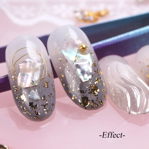 Irregular iridescent shell flakes and gold foil nail art on gradient gray nails