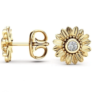 Close-up of 18k gold sunflower earrings with sparkling white cubic zirconia center stones