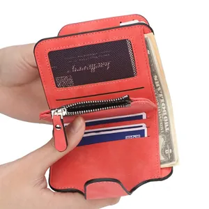 Red folding wallet with matte faux leather finish showing interior card slots and zipper pocket