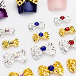 Hollow bow nail art charms with colorful rhinestones in gold and silver finish