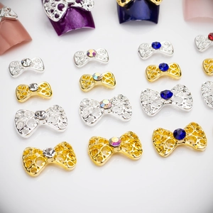 Hollow bow nail art charms with rhinestones in gold and silver alloy finish