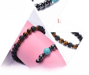 Macro detail of natural tiger eye, lava rock and turquoise energy beads on a healing bracelet