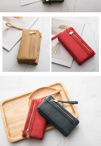 Retro multi-functional women's long wallets in various colors on marble and wood backgrounds