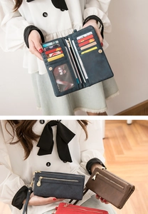 Detail view of multi-compartment faux leather long wallets in blue, brown, and red colors