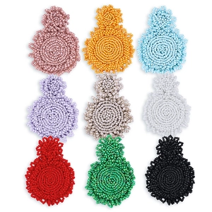 Macro shot of colorful seed bead earrings in nine vibrant bohemian woven styles