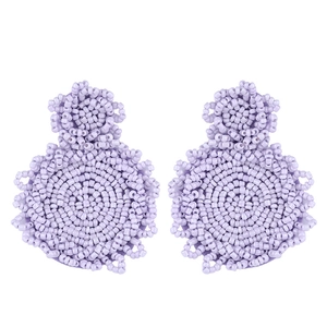 Close-up of lavender handmade seed bead earrings with bohemian floral pattern design
