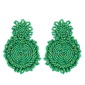 Detail of green beaded drop earrings featuring intricate handmade woven texture