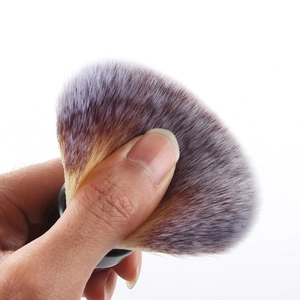 Close-up showing the soft, dense synthetic bristles and flexibility of the large powder brush