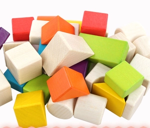 Close-up of colorful geometric wooden blocks including cylinders and cubes for kids