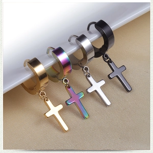 Detail showing four multi-colored stainless steel cross earrings on a white porcelain edge