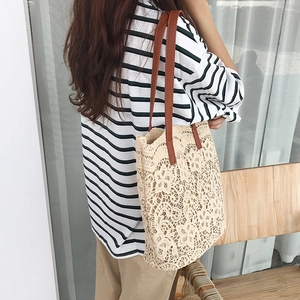 Close-up of cream floral crochet lace tote bag with premium brown leather straps