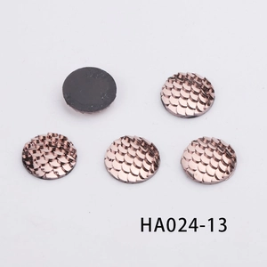 Detail of 16mm round resin fish scale cabochons with rose gold texture and flat black back
