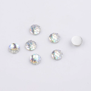 Macro detail of 8mm round fish scale resin cabochons with iridescent AB finish for DIY crafts
