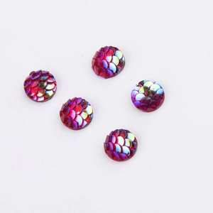 Macro shot of 8mm round red iridescent fish scale resin cabochons on white background