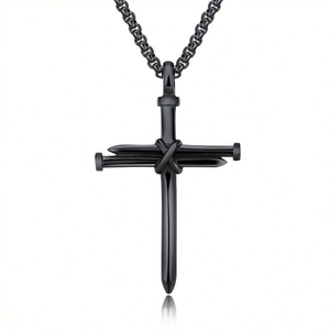 Industrial black stainless steel nail cross pendant necklace on a pure white background