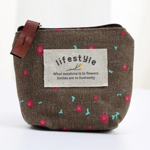 Brown canvas coin purse with embroidered floral patterns and zipper closure