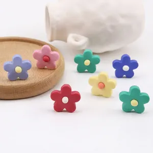 Colorful resin flower beads for DIY jewelry making displayed on a wooden plate