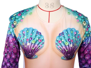 Detail of mermaid shell print and purple scale patterns on a long-sleeve costume top