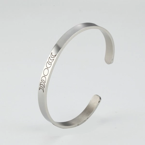 Detailed side view of 6mm silver stainless steel open bangle with moon phase engraving
