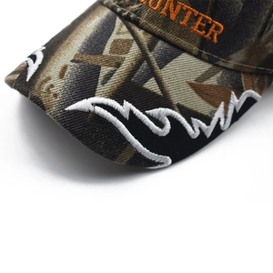 Detail view of camouflage baseball cap featuring orange HUNTER embroidery and wavy stitching