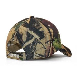 Detailed view of camo baseball cap with white Choppers embroidery on the adjustable strap