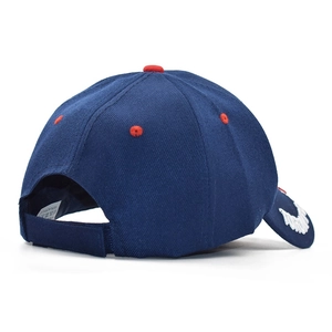 Detail of navy baseball cap with red ventilation holes and adjustable velcro strap closure