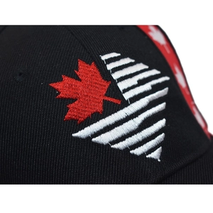 Close-up of premium embroidery featuring a red maple leaf on a black baseball cap