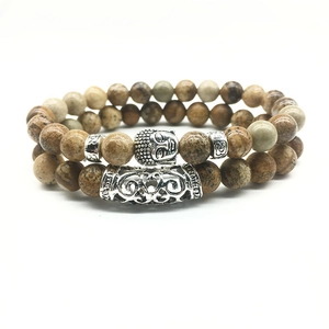 Set of two beaded bracelets with Buddha head and patterned tube in natural stone