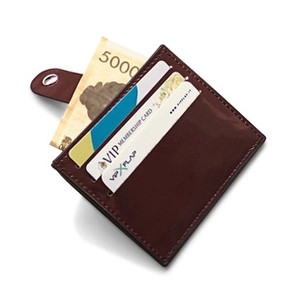 Detailed view of dark brown quilted leather card holder featuring accordion slots and snap closure