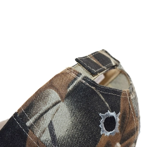 Close-up of camouflage baseball cap with adjustable Velcro strap and circular embroidery