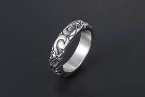 Close-up of vintage silver ring featuring engraved star and acanthus leaf patterns
