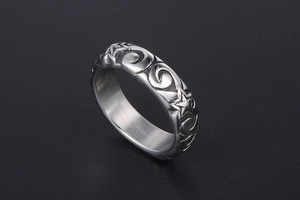 Detailed view of vintage star and wave pattern engravings on a metallic ring band