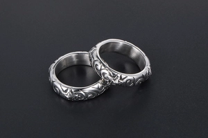 Detailed view of silver rings featuring engraved star patterns and polished metal texture