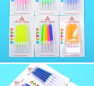 Close-up of colorful spiral birthday candles in vibrant multi-color packs on blue background