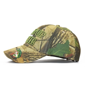 Close-up of jungle camo baseball hat featuring fish embroidery and slogan on white background