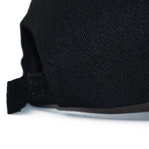 Close-up of black twill cotton baseball cap with adjustable Velcro strap closure