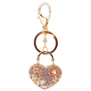 Golden heart keychain featuring flower enamel, amber gemstone, and crystal accents