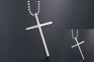 Detail of silver titanium steel cross pendant with ball chain and sleek metallic finish