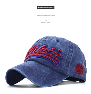 Detail of red 3D athletic embroidery on navy blue washed vintage cotton baseball cap