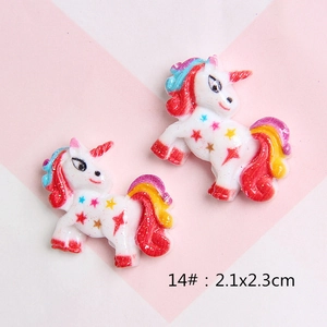 Macro detail of resin glitter unicorn DIY charm with stars and rainbow gradient mane