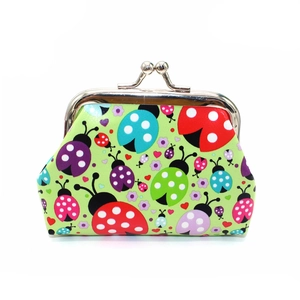 Detail of ladybug pattern coin purse with vintage metal clasp and waterproof faux leather