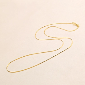 S925 sterling silver golden snake bone chain necklace with spring clasp on beige fabric