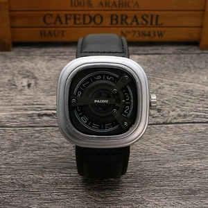 Macro view of square silver case with unique rotating disc dial and black leather strap