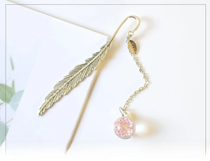 Detailed silver feather metal bookmark with a pink dried flower glass ball pendant