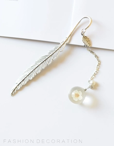 Detail of silver feather metal bookmark with white dried flower resin ball pendant