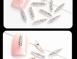 Close-up of boat-shaped nail alloy charms with white and AB rhinestones